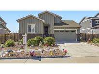 Attractive home featuring grey siding, brick accents, and a manicured lawn at 6924 E 118Th Pl, Thornton, CO 80233