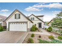 Charming two-story home featuring a well-manicured lawn, mature landscaping and a two car garage at 3841 Colorful Ln, Castle Rock, CO 80109