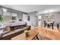 Cozy living room featuring hardwood floors and a comfortable brown couch with outdoor access at 7973 Chase Cir # 56, Arvada, CO 80003