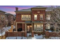 Beautiful two-story brick home featuring a covered front porch and charming architectural details at 9461 Elmhurst Ln # C, Highlands Ranch, CO 80129
