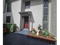 Inviting front entrance with decorative planters and a cozy bench, creating a warm welcome to the home at 7925 W Layton Ave # 322, Littleton, CO 80123