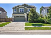 Charming two-story home showcasing a well-manicured lawn, inviting curb appeal, and a two-car attached garage at 428 Starline Ave, Lafayette, CO 80026