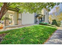 Two-story home with a well-manicured lawn and tasteful stone accents on the front porch columns at 13033 Grant E Cir # B, Thornton, CO 80241