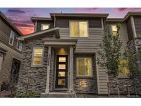 Two-story home with stone and siding exterior, modern entryway at 24257 E 41St Ave, Aurora, CO 80019