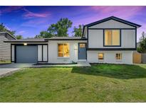 Charming two-story home with a well-maintained lawn, painted in white and gray at 9605 Carr St, Broomfield, CO 80021