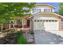 Charming two-story home with a brick facade and well-maintained landscaping in a suburban neighborhood at 1441 Cherry Pl, Erie, CO 80516