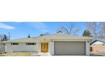 Charming ranch-style home with brick exterior, an attached two-car garage and a well-manicured front lawn at 3293 S Florence Ct, Denver, CO 80231