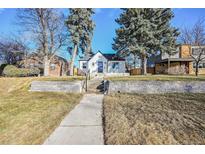 Charming home featuring a well-maintained lawn and inviting front entrance steps at 2380 Jasmine St, Denver, CO 80207