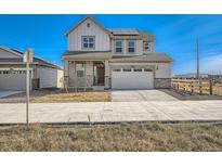 Two-story house with solar panels, attached garage, and landscaping at 196 Kino Ct, Brighton, CO 80601