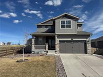 Charming two-story home featuring a covered porch, two-car garage, and meticulous landscaping at 914 Peach Leaf Ln, Elizabeth, CO 80107
