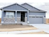 Charming single-Gathering home featuring a stone-accented facade and an attached two-car garage at 17170 E 90Th Pl, Commerce City, CO 80022