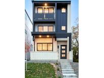 Modern three-story home featuring black metal accents, balconies, and a charming covered front porch at 3435 W 17Th Ave, Denver, CO 80204