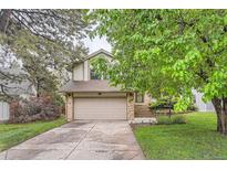 Charming two-story home with a well-maintained lawn and a two-car garage in a mature neighborhood at 6443 S Florence Way, Englewood, CO 80111