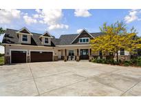 A beautiful home with a well manicured lawn, dormer windows, and a large driveway at 3048 Deer Creek Ranch Loop, Parker, CO 80138