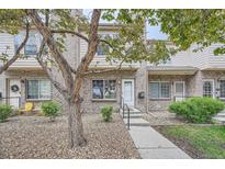 Charming brick townhouse featuring a well-maintained front yard and a welcoming entrance at 3033 W 107Th Pl # D, Westminster, CO 80031