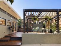 Inviting backyard with wood deck, outdoor seating under pergola, and tasteful landscaping create a relaxing space at 4138 N Federal Blvd, Denver, CO 80211