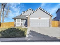 Charming gray home with a well-manicured lawn and an attached two-car garage at 18383 E Union Dr, Aurora, CO 80015
