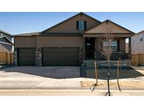 Two-story home featuring a three-car garage, covered porch, and a combination of siding and stone accents at 16113 Alpine Sorrel Dr, Monument, CO 80132