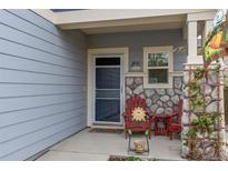 Charming front porch with stone accents, welcome mat, and cozy seating creates a warm entrance at 6210 Wescroft Ave, Castle Rock, CO 80104