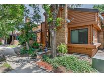 Charming townhouse with brick and wood siding, featuring a well-manicured front yard at 2685 S Dayton Way # 253, Denver, CO 80231