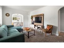 Inviting living room with stylish furniture, decor, and a view into the adjacent dining area at 60 Vrain St, Denver, CO 80219