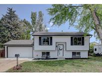 Charming two-story home featuring a well-maintained front yard and attached garage at 5945 W 86Th Ave, Arvada, CO 80003