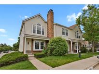 Charming two-story townhome with a well-maintained front yard and brick chimney at 14396 E Temple Pl # D, Aurora, CO 80015