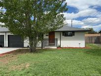 Charming single-story home features a well-manicured lawn and updated exterior at 4670 Independence St, Wheat Ridge, CO 80033