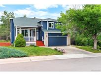 Charming two-story home featuring a well-maintained lawn and a two car garage at 4257 S Andes Way, Aurora, CO 80013