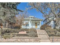 Charming single-story home with a bright yellow front door and inviting curb appeal at 3427 W 29Th Ave, Denver, CO 80211