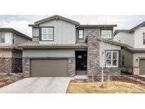 Beautiful home with stone accents, a two-car garage, and well-maintained landscaping at 533 Red Thistle Dr, Highlands Ranch, CO 80126