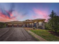 Beautiful two-story house featuring a three-car garage, stone accents, and a welcoming front porch at 1272 Nightfire Cir, Castle Rock, CO 80104