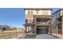 Stunning two-story home featuring a brick exterior and a balcony above the garage at 15646 W Floyd Dr, Morrison, CO 80465