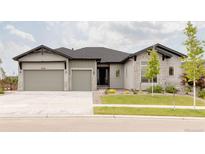 Charming single Gathering home showcasing a well-manicured lawn, stone accents, and a three-car garage at 6608 S White Crow Ct, Aurora, CO 80016