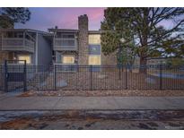 Charming condo with a stone facade, private balconies and a decorative iron fence for enhanced curb appeal at 4400 S Quebec St # 101N, Denver, CO 80237