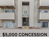Apartment building exterior featuring private balconies, multiple units, and central entrance at 10150 E Virginia Ave # 6-305, Denver, CO 80247