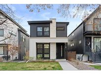 Modern two-story home with a combination of stone and dark siding, plus manicured front lawn at 3646 Quivas St, Denver, CO 80211