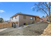 Two-story home with a modern design, light brick, and a two car garage on a beautiful lot at 900 S Webster St, Lakewood, CO 80226