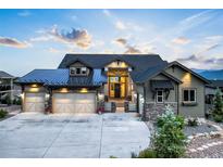 Beautiful home featuring a three car garage and manicured landscaping at 16486 Florawood Pl, Monument, CO 80132