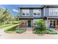 Charming two-story townhouse with a covered front porch and well-maintained landscaping at 1459 S Pierce St, Lakewood, CO 80232