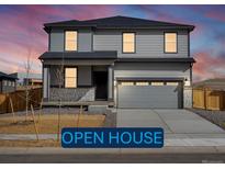 Two-story home boasts gray siding, stone accents, and a spacious two-car garage with an open house banner in front at 8820 Sedalia St, Commerce City, CO 80022