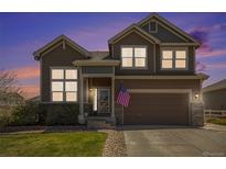 Inviting two-story home featuring a well-manicured lawn and an attached two-car garage at 5404 Fawn Ridge Way, Castle Rock, CO 80104