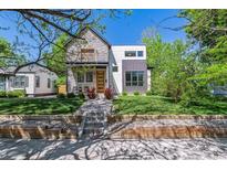 Modern two-story home boasts professional landscaping, a stone facade, and a contemporary design at 1911 S Lafayette St, Denver, CO 80210
