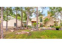 Contemporary home featuring unique design elements, rock landscaping and mature trees at 1250 Dolan Dr, Monument, CO 80132