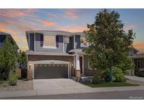 Charming two-story home featuring a brick facade, gray siding, and a well-manicured front yard at 15675 E Kettle Pl, Centennial, CO 80112