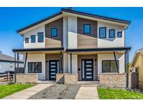 Modern duplex with stylish black windows, neutral paint scheme, and inviting entrances with brick accents at 964 Quitman St, Denver, CO 80204