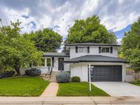 Charming two-story home with lush landscaping, inviting entrance and well-maintained front yard at 3793 S Sebring Ct, Denver, CO 80237