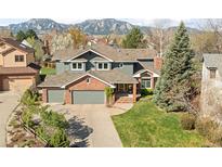 Charming home with brick accents, a three-car garage, mature trees and mountain views at 1437 Cassin Ct, Boulder, CO 80303