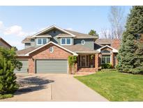 Charming two-story home features a well-manicured lawn, brick accents, and an attached two-car garage at 1437 Cassin Ct, Boulder, CO 80303