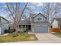 Charming two-story home with a well-manicured lawn, attached two-car garage and a welcoming covered porch at 16420 Martingale Dr, Parker, CO 80134